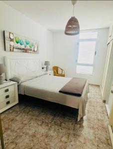 a bedroom with a large bed and a window at Casa TIN TIN Lanzarote in Tías