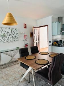 a dining room table and chairs in a kitchen at Casa TIN TIN Lanzarote in Tías +17 photos