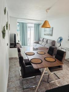 a living room with a table and a couch at Casa TIN TIN Lanzarote in Tías