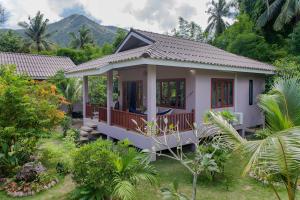 a small house in the middle of a garden at Boonya Swiss Home in Chaloklum