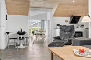 a living room with a table and chairs at LF12172-Vinderup-Strandlyst-29 in Vinderup