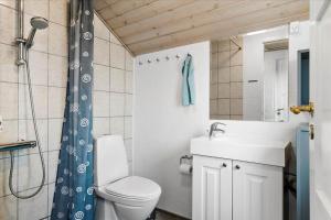 a bathroom with a toilet and a sink and a shower at LF12172-Vinderup-Strandlyst-29 in Vinderup +26 photos