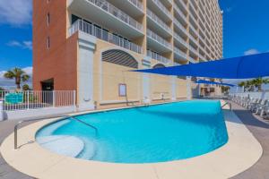 a large swimming pool in front of a building at San Carlos Unit 607 in Gulf Shores