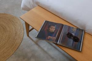 a book sitting on a table next to a bed at Boonya Swiss Home in Chaloklum