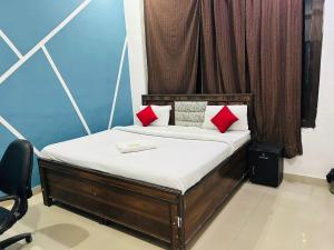 a bed with red pillows in a room at Hotel Comfy Point - Sec 44 Noida in Noida