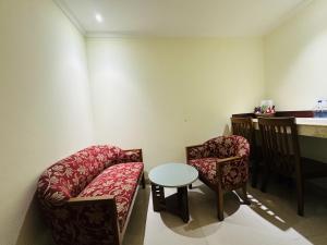 a room with a couch and two chairs and a table at Uni Resort in Cox's Bazar