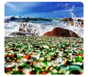 a pile of glass beads on a beach near the ocean at Vivienda Turística Ático in Laxe
