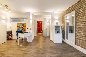 a room with a desk and a brick wall at Casa Wohnen und Wellness in Hemer