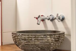 a bathroom sink with a faucet on top of it at Casa Wohnen und Wellness in Hemer +30 photos