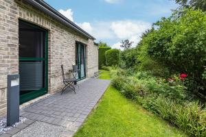a patio with a chair next to a building at Casa Wohnen und Wellness in Hemer