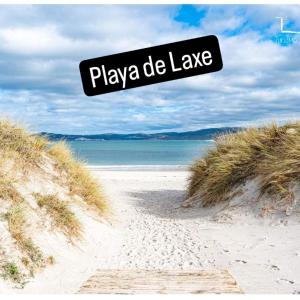 a sign that reads playa de laalle on a beach at Vivienda Turística Ático in Laxe