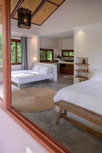 a bedroom with two beds and a large mirror at Boonya Swiss Home in Chaloklum +229 photos