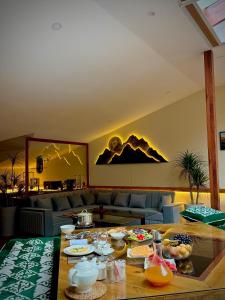 a living room with a table with food on it at 2149 Hotel in Khorog