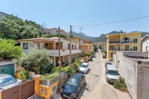 a street in a town with cars parked on the street at Attico Bella Vista in Siniscola