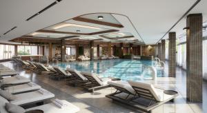 a swimming pool with lounge chairs and a hotel at Panorama Mountain Tara in Kaludjerske Bare