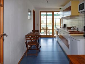 a kitchen with a counter and a table and chairs at Ferienwohnung Bieber in Seiffen