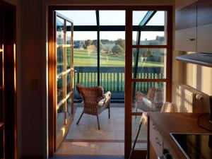 a kitchen with a view of a balcony with chairs at Ferienwohnung Bieber in Seiffen +25 photos
