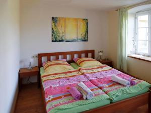 a bed with blankets and pillows on top of it at Ferienwohnung Bieber in Seiffen