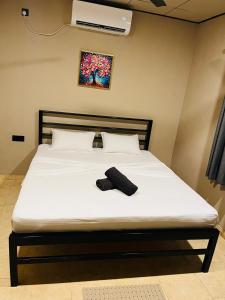 a bed with a pair of shoes sitting on it at Hiri Hideout in Dickwella