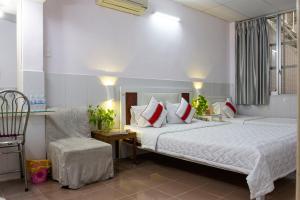 a bedroom with a large bed and a chair at QUANG SAIGON Hotel- 40-7 Bùi Viện-Walking street in Ho Chi Minh City