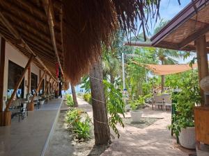 a restaurant with tables and chairs on the beach at Banana Beach Club in Moalboal