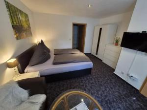a hotel room with two beds and a flat screen tv at Neu!!! Pension Scherz-ruhig am Standrand mit Wasserzugang & Paddelboot in Lübbenau