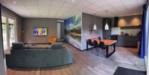 a kitchen and dining room with a table and a couch at The Mansion in Wijnjewoude