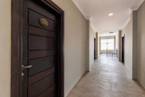 a hallway with a door with a number on it at Hotel O near RSUD Arifin Achmad formerly Damon Butik Hotel in Limbangan +16 photos
