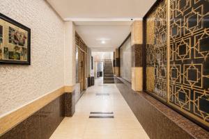 a hallway of a building with art on the walls at Hotel O near RSUD Arifin Achmad formerly Damon Butik Hotel in Limbangan
