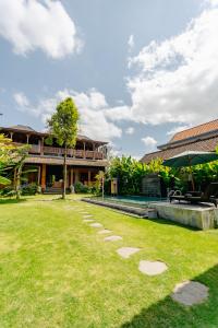 a lawn in front of a house at Rana Suite in Ubud