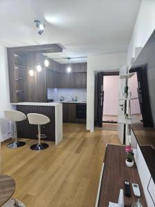 a kitchen with a table and two chairs in a room at Apartman Marija IV in Vrnjačka Banja