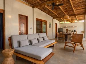 a living room with a couch and a table at HAMA Villa with private pool in El Nido