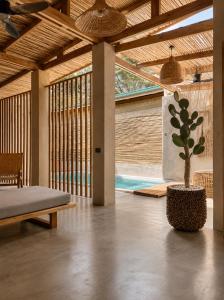 a room with a bed and a potted plant at HAMA Villa with private pool in El Nido