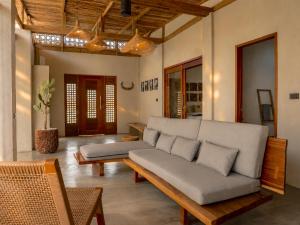 a living room with a couch and a table at HAMA Villa with private pool in El Nido
