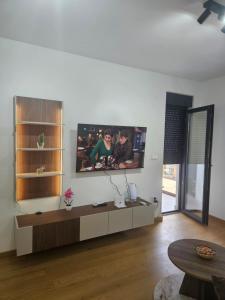 a living room with a flat screen tv on the wall at Apartman Marija IV in Vrnjačka Banja