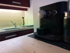 a kitchen with a sink and a microwave at Ferienwohnung Stern, Natters in Innsbruck