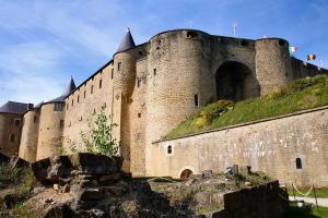 a large castle sitting on top of a hill at So Chic Romance au pied du Château in Sedan
