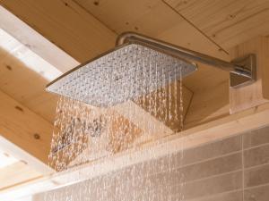 a shower head with water coming out of it at Saunaloft Schwarzwald in Gemeinde Aichhalden +22 photos