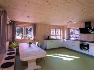 a kitchen with a wooden table in a room at Saunaloft Schwarzwald in Gemeinde Aichhalden