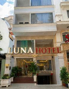 a luna hotel sign on the side of a building at LUNA Hotel in Ho Chi Minh City