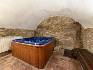 a blue tub in a room with a stone wall at Casa Nabarro in Iturgoyen