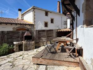 a patio with a table and chairs and a grill at Casa Nabarro in Iturgoyen