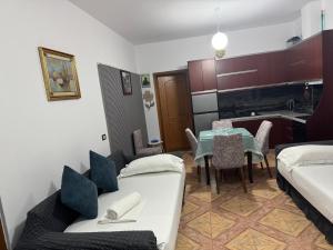 a living room with a couch and a table at Elmir apartament's in Ksamil