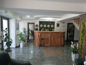 a kitchen with a island in a room with plants at Hotel Racu Family in Komrat +28 photos