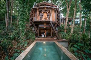 a tree house in the woods with a pool at Ant House Sidemen in Silebeng