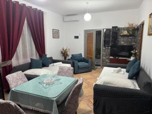 a living room with a couch and a table at Elmir apartament's in Ksamil