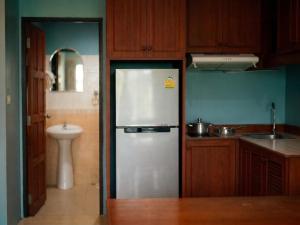 a kitchen with a stainless steel refrigerator and a sink at Orient Hotel in Jomtien Beach +26 photos