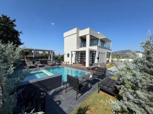 a villa with a swimming pool and a house at Mamica Luxury Villa in Laganas