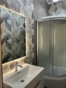 a bathroom with a sink and a mirror and a tub at Дача в городе in Bishkek +40 photos