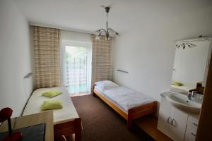 a bedroom with a bed and a sink and a mirror at Haus die Gerti - Ilz in Waldkirchen